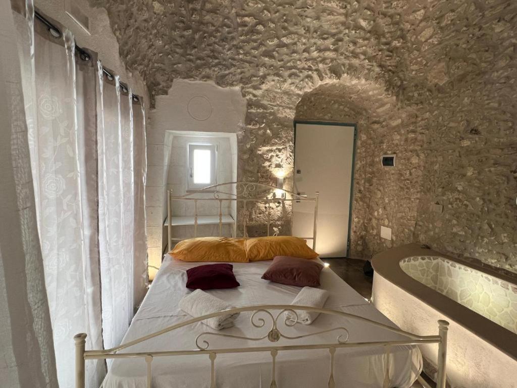 a bedroom with a bed and a bath tub at Maison Carolina in Vieste