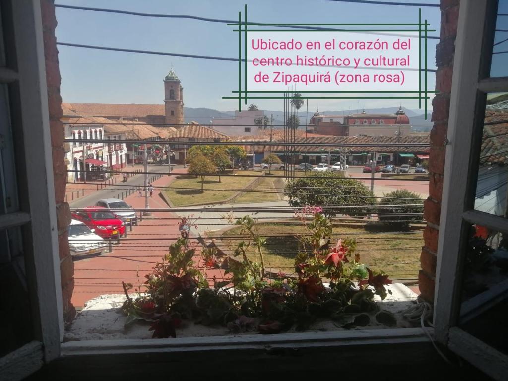 uma janela aberta com vista para uma cidade em MACONDO apartamento turistico tematico em Zipaquirá