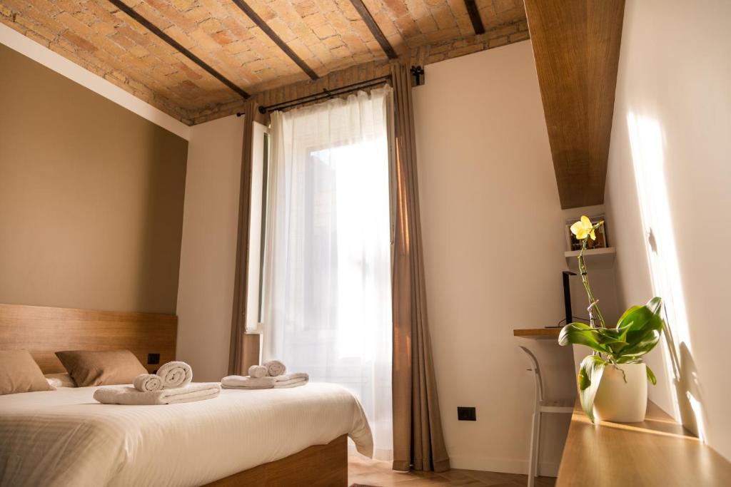 a bedroom with a bed and a large window at Testaccio Boutique Apartment in Rome in Rome