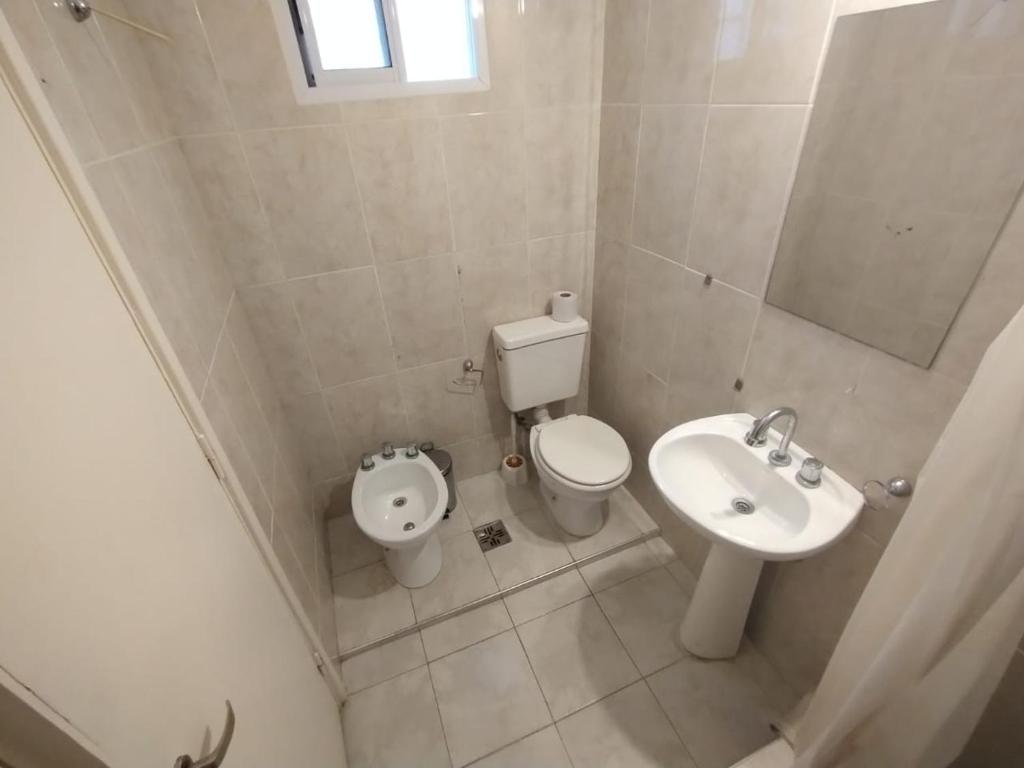 a small bathroom with a toilet and a sink at Carlos VII in Mar del Plata