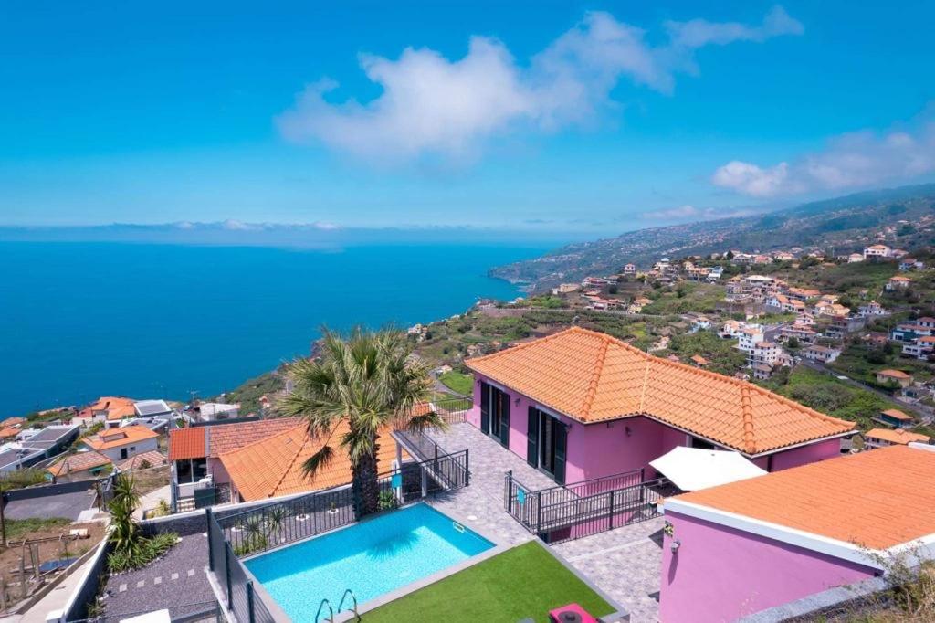 a villa with a swimming pool and a view of the ocean at Villa Rosa with private pool by HR Madeira in Ribeira Brava