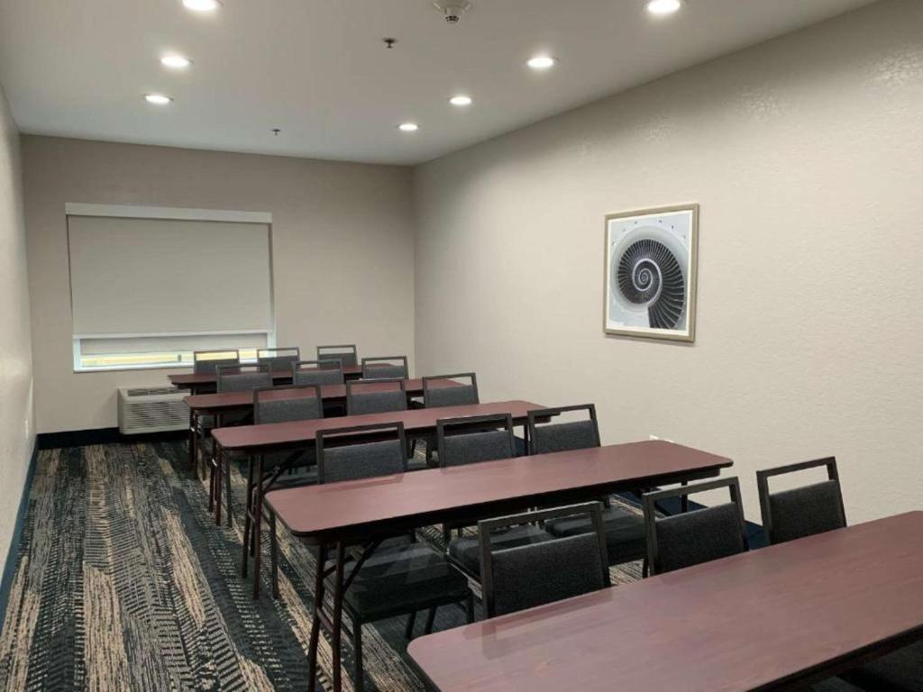 a conference room with tables and chairs and a whiteboard at Best Western Houston Bush IAH Intercontinental Airport Inn in Humble