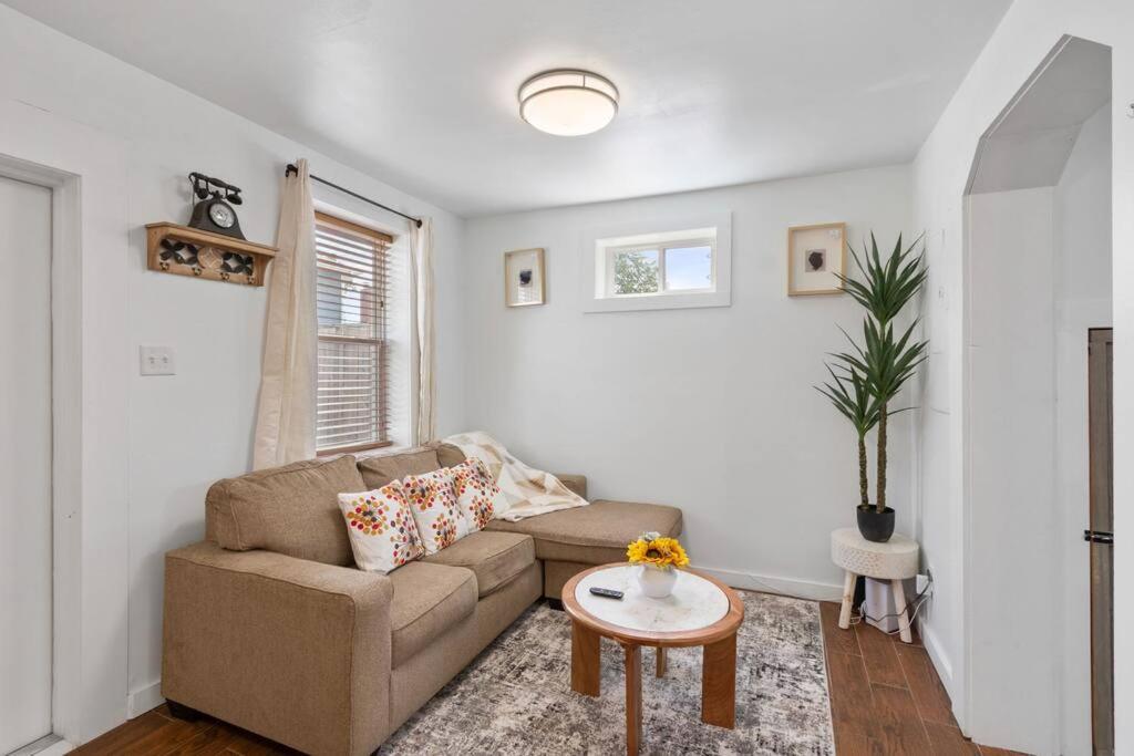 a living room with a couch and a table at Warm Villa 1 block to Mary Washington Campus in Fredericksburg