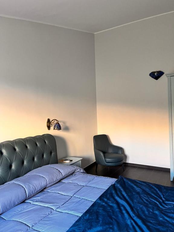 - une chambre avec un lit et une chaise dans l'établissement Residence La Torre, à Acerenza