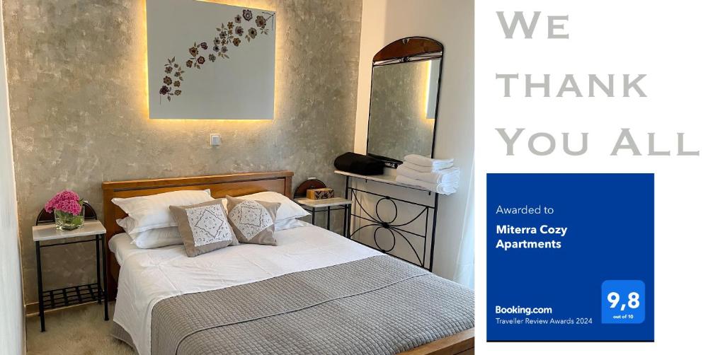una camera con un letto e un cartello che dice grazie a tutti di MiTerra Cozy Apartments a Andritsaina