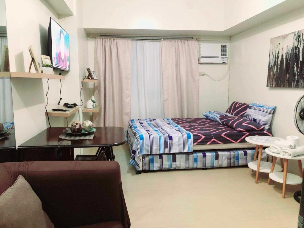 Llit o llits en una habitació de Avida Atria Tower I Cozy Condo Great Location