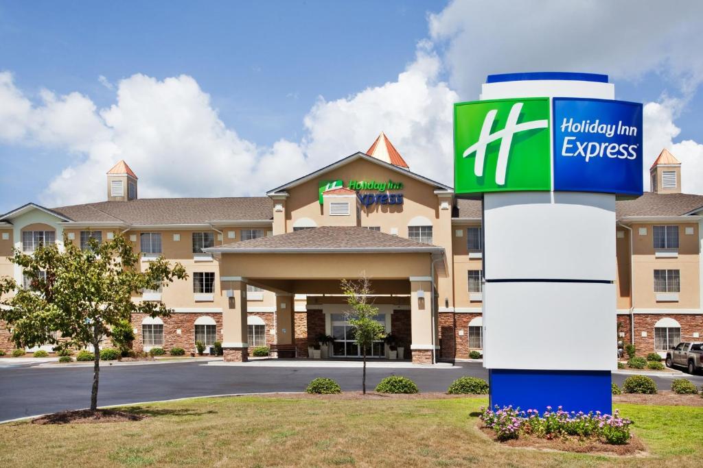 a hotel with a sign in front of a building at Holiday Inn Express Savannah Airport, an IHG Hotel in Savannah