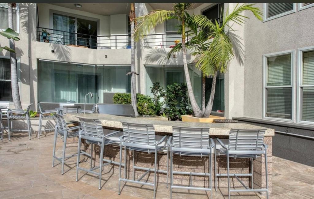 a patio with a table and chairs in front of a building at Nautical 2 Bedroom in the of Heart Marina del Rey in Los Angeles