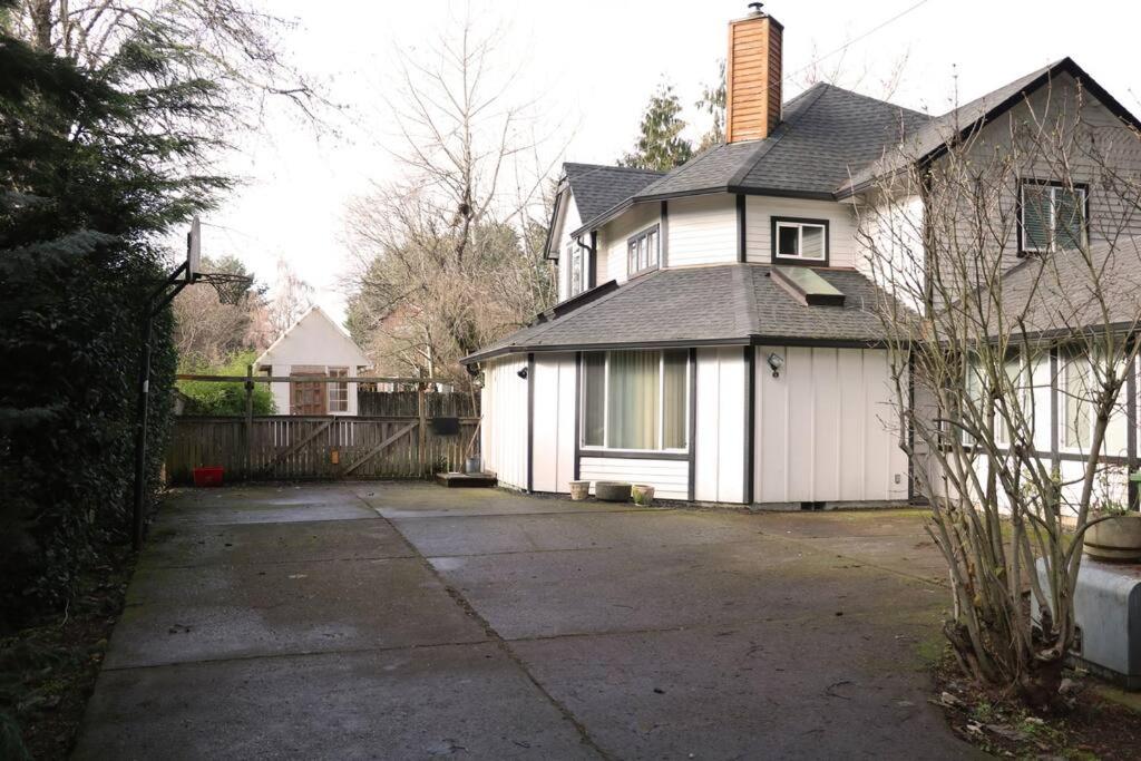 a white house with a driveway in front of it at Whitaker 5 bdrm Daily-Weekly-Monthly in Eugene
