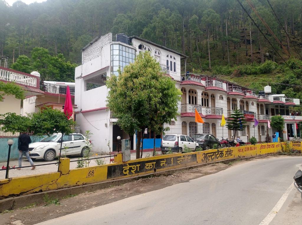 a group of buildings on the side of a street at Hotel diyaraj barkot sarukhet in Barkot