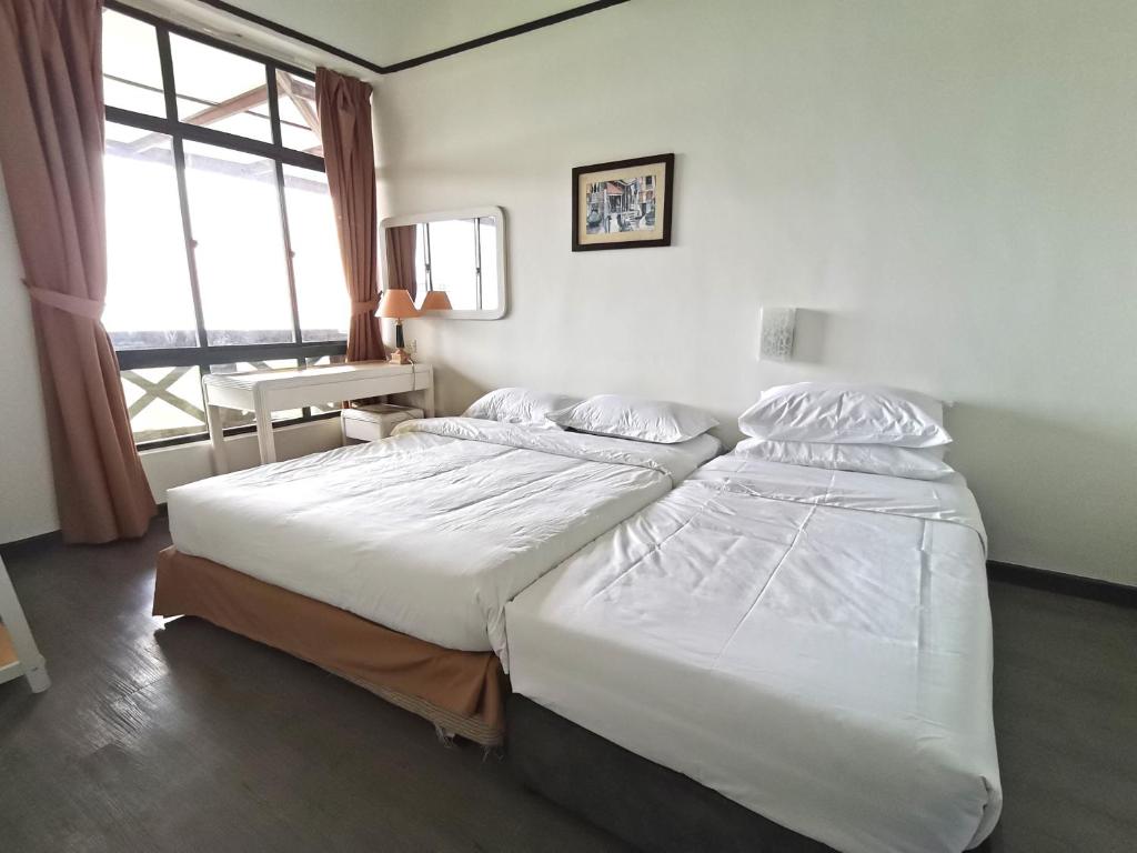 a large bed in a room with a large window at Costa Mahkota Sea view 1-Bedroom Retreat in Melaka