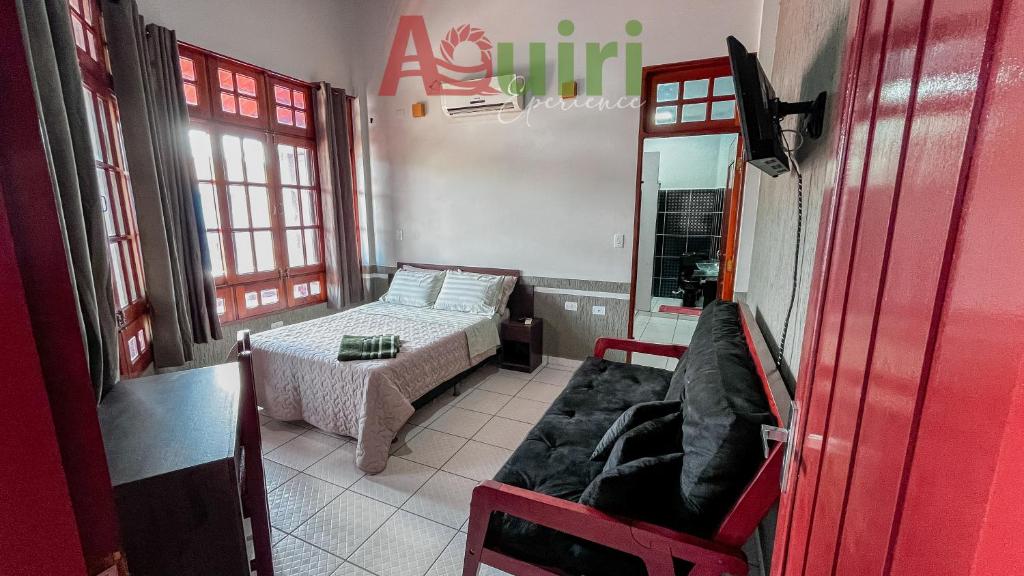 a small room with a bed and a couch in it at Departamento cómodo y céntrico in Cobija