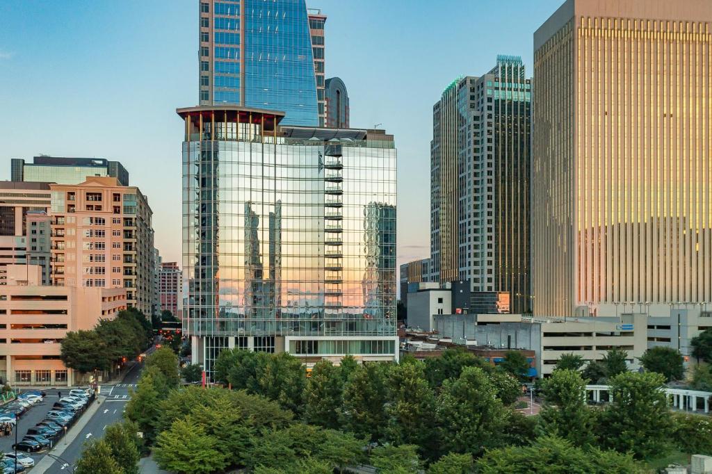 a city skyline with many tall buildings and cars at Kimpton Tryon Park Hotel, an IHG Hotel in Charlotte
