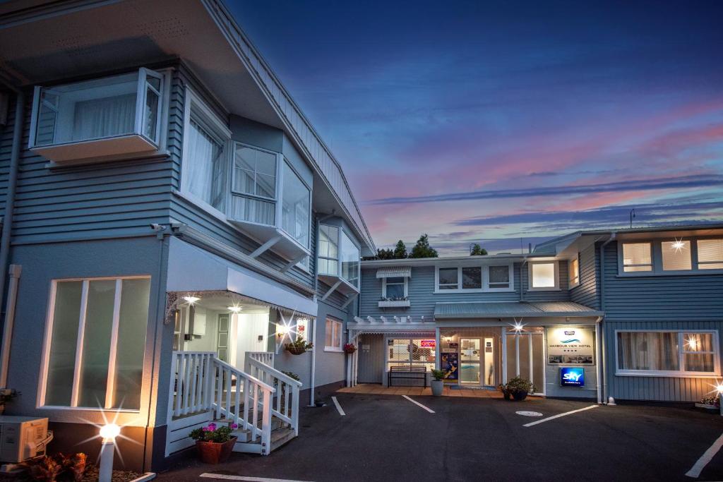 a house with a parking lot in front of it at ASURE Harbour View Motel in Tauranga