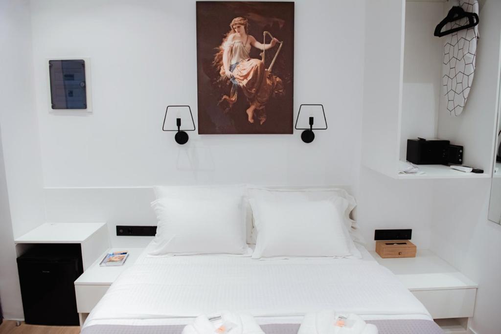 Postel nebo postele na pokoji v ubytování Athens Muses Suites