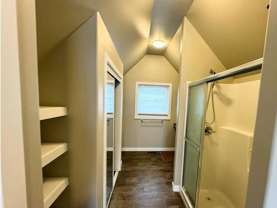 a bathroom with a walk in shower and a window at 3 BDR - Bonus Room - King Bed - Garage - Near Airport in Regina