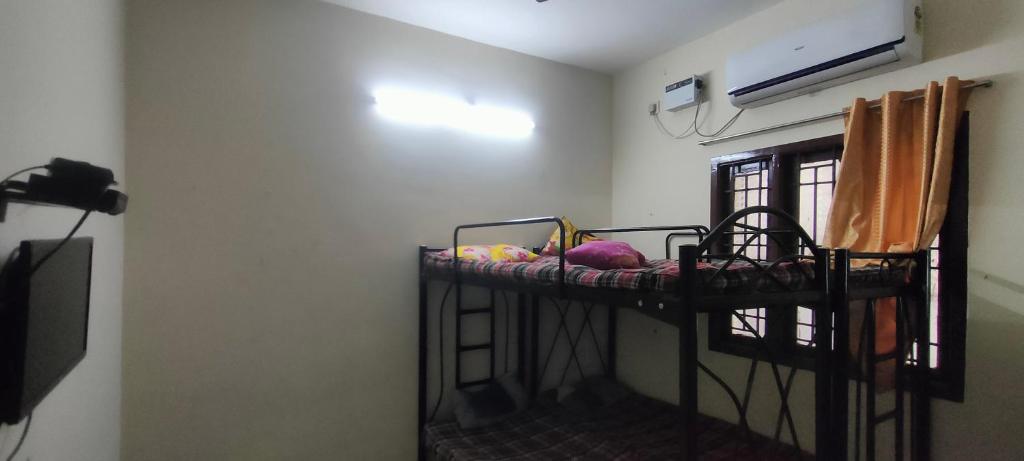 a room with a bunk bed in a room at Kingdom of dorms-the shared room in Chennai