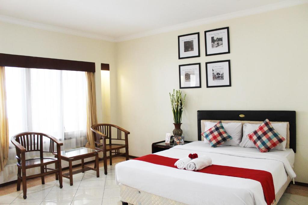 Postel nebo postele na pokoji v ubytování Hotel Pelangi Malang, Kayutangan Heritage