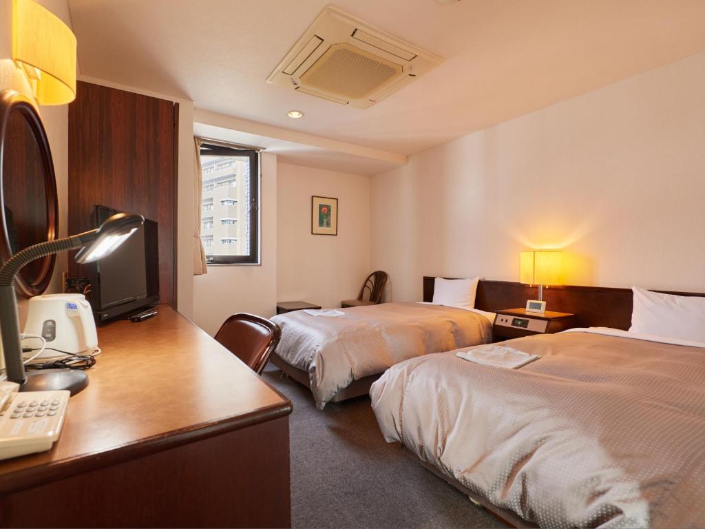 Postel nebo postele na pokoji v ubytování Tabist Hotel New Central