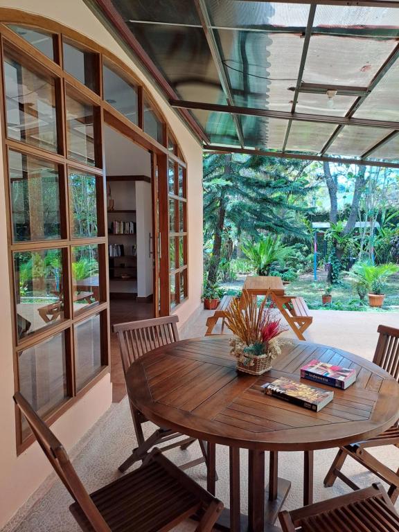 a dining room with a wooden table and chairs at Wonderful Villa Felice in Yogyakarta