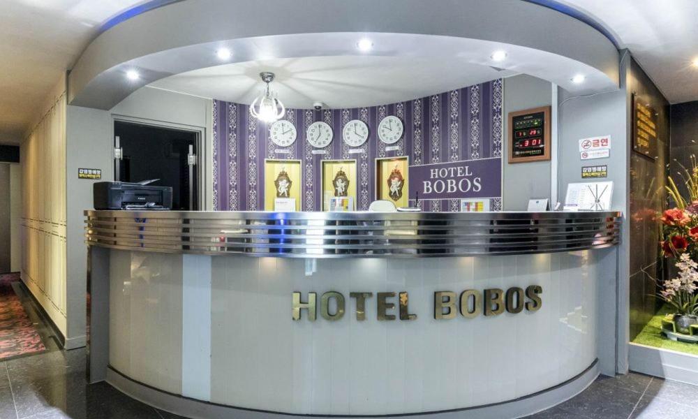 a hotel lobby with a hotel lobos sign in a building at Dongtan BobosHotel in Hwaseong