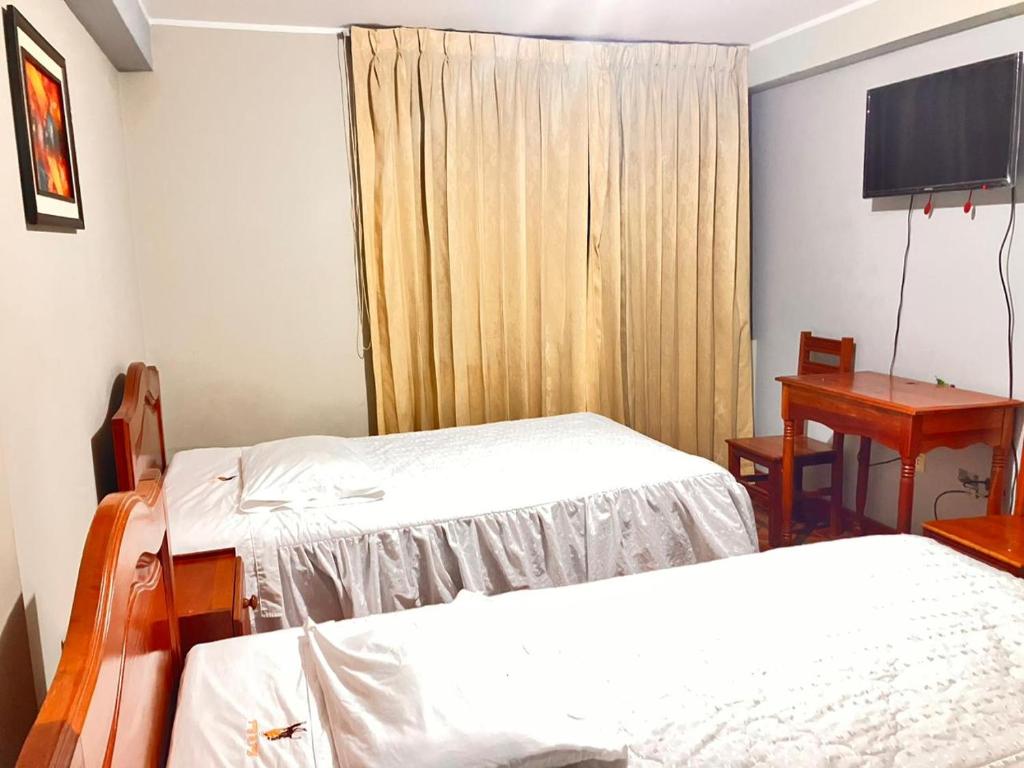 Postel nebo postele na pokoji v ubytování Hostal El Rancho