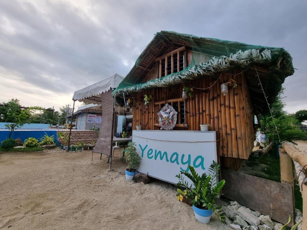 a small house with a sign in front of it at Yemaya de Laiya powered by Cocotel in Biga