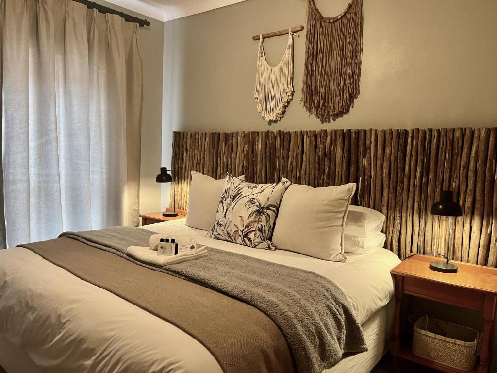 a bedroom with a large bed and a window at The Boshoff in Durban