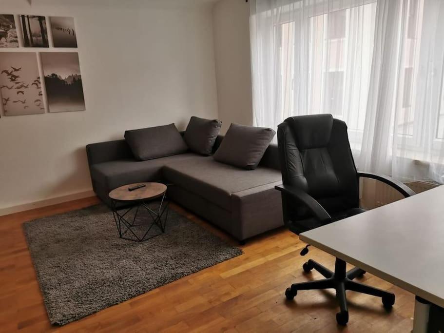 a living room with a couch and a table at delblaiso suite in Memmingen