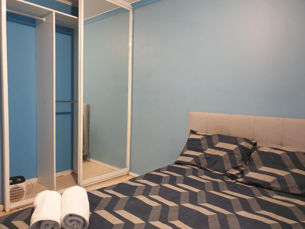 a bedroom with a bed and a window at Private room with shared facilities W in Werribee