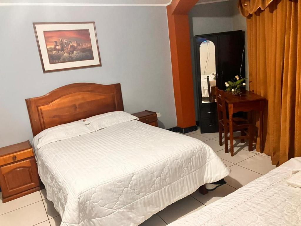 Postel nebo postele na pokoji v ubytování Hostal El Rancho