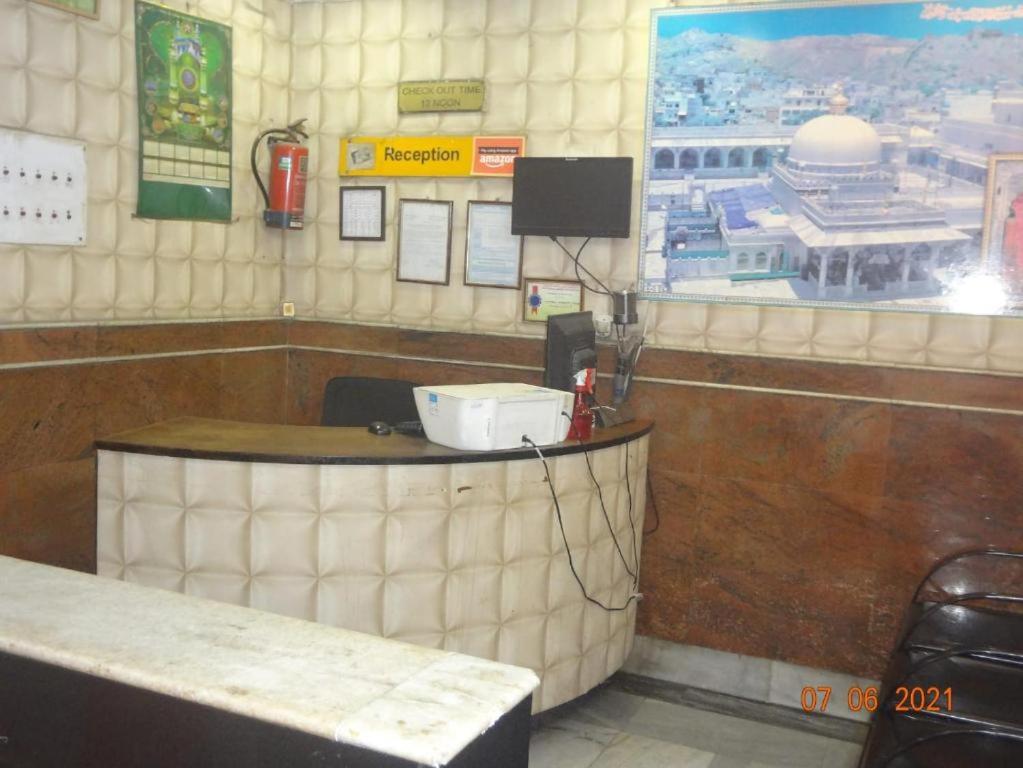 a counter in a restaurant with avertisement at Khaja Hotel in Kolkata