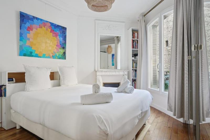 Säng eller sängar i ett rum på Charmant Apt Familial - Montmarte