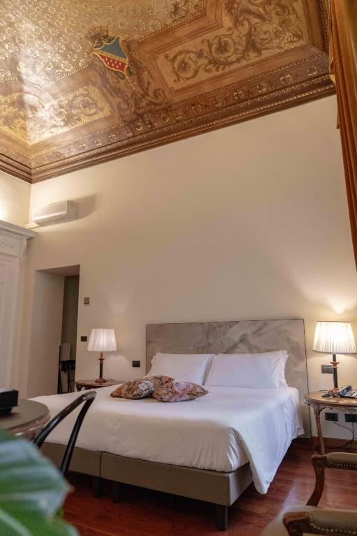 Postel nebo postele na pokoji v ubytování Hotel Bologna