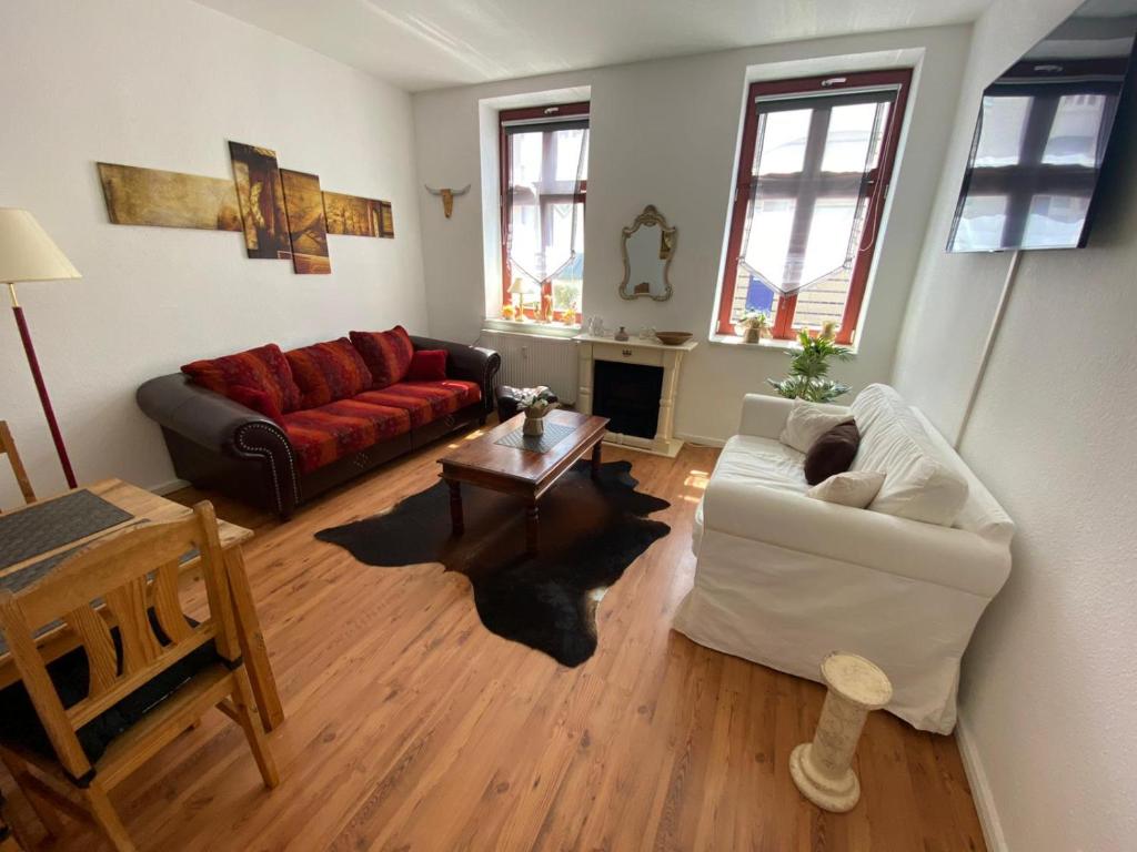 a living room with a couch and a table at Traumwohnung STÖRTEBEKER ruhig & großzügig zentral in Rostock