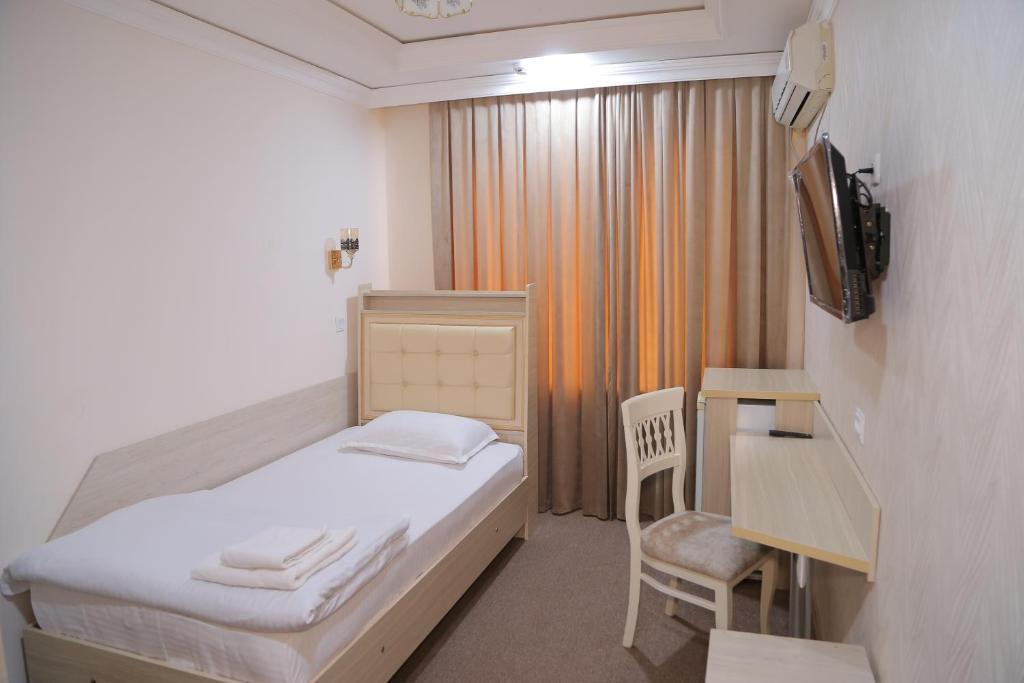 Voodi või voodid majutusasutuse URGANCH HOTEL toas