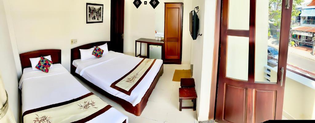 Postel nebo postele na pokoji v ubytování Hoian Old Town Hostel