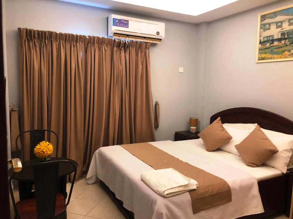 a bedroom with a large bed and a window at Everest Hotel Apartments in Sharjah