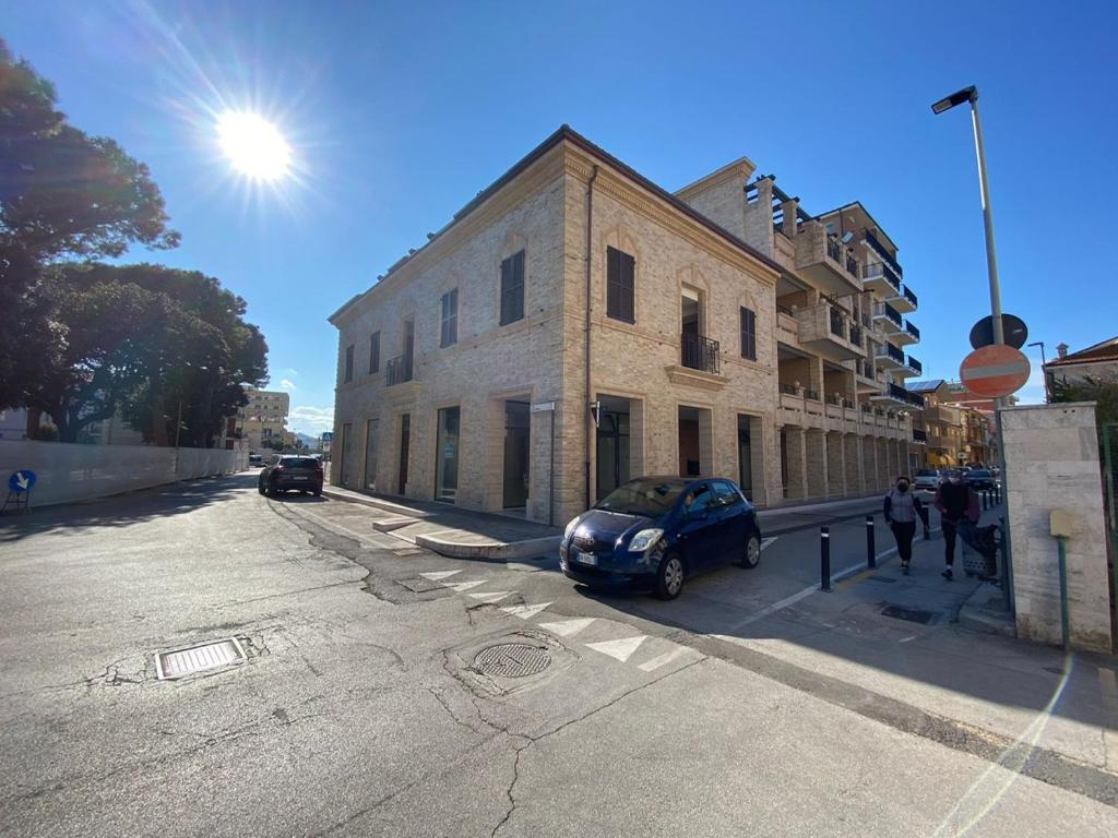 a car parked in front of a building on a street at Charming Apts - Via Pastrengo in Porto Recanati