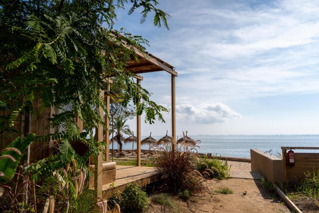 a pavilion on the beach next to the ocean at Alfacs Village in Les Cases d'Alcanar