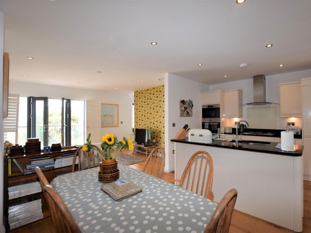 a kitchen and dining room with a table and chairs at 3 Bed in Ilfracombe 42432 in Ilfracombe