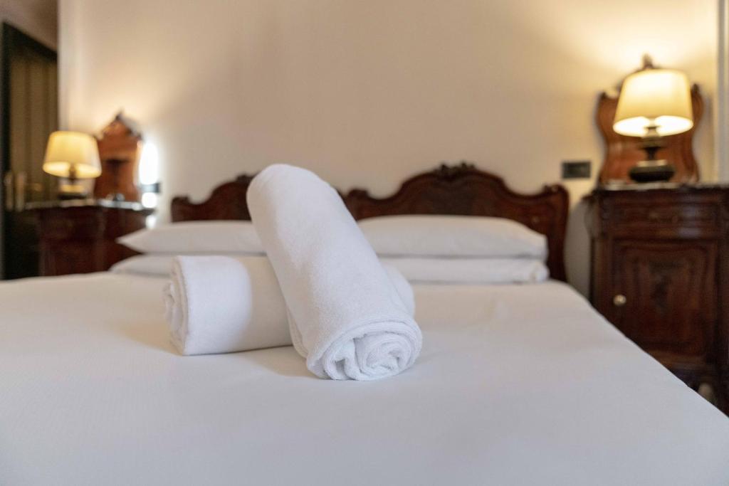 Postel nebo postele na pokoji v ubytování Hotel Bologna
