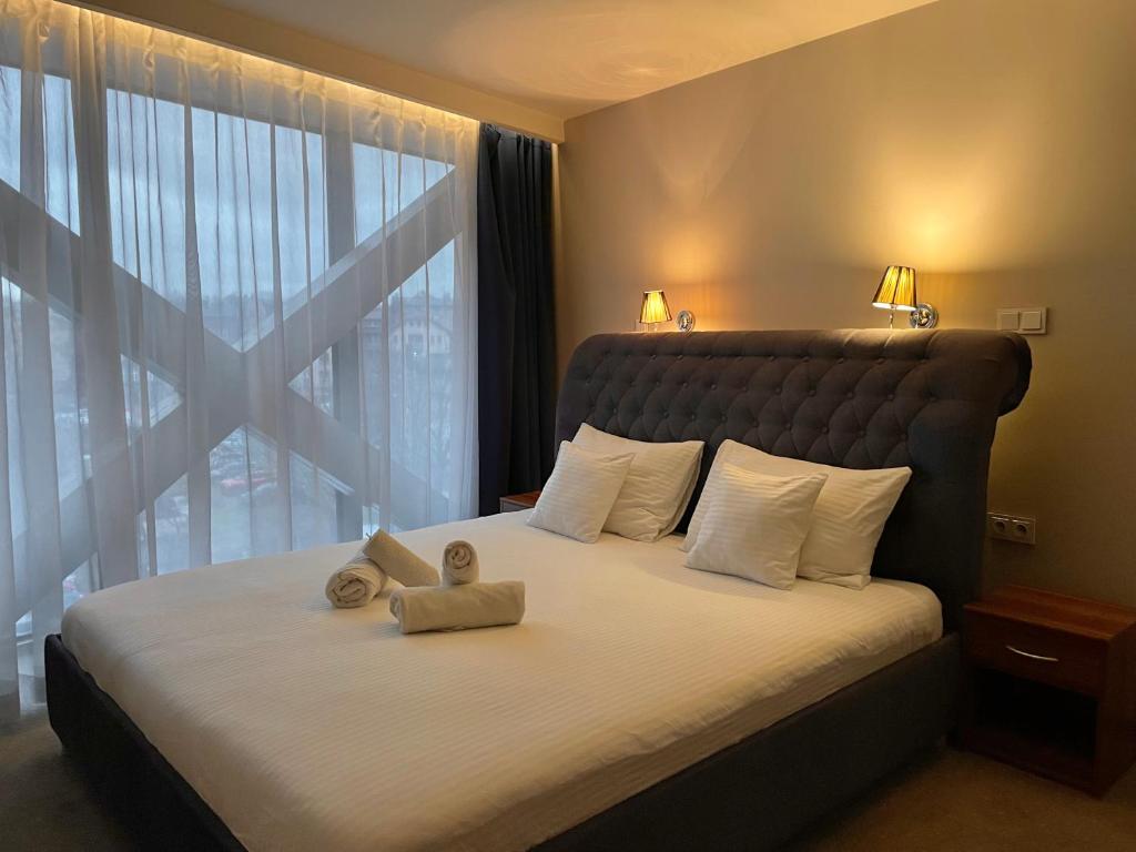 a bedroom with a large bed with a large window at Black Gold Center in Chorzów