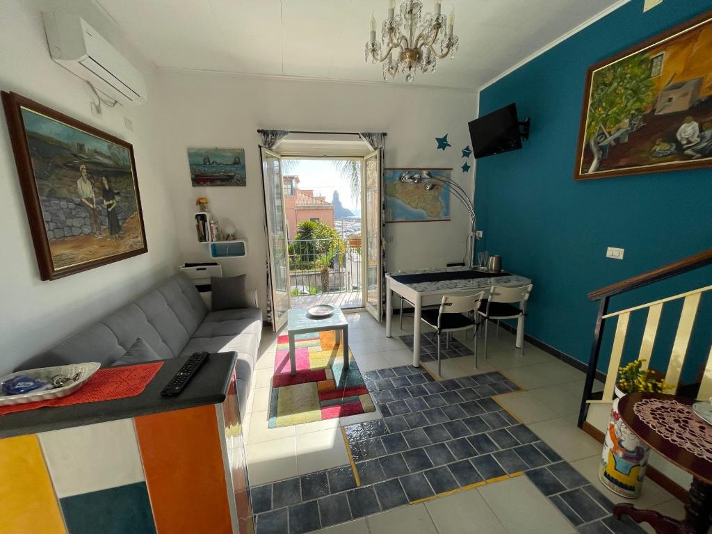 a living room with a couch and a table at Suite 53 in Acitrezza