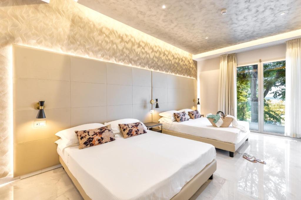 Postel nebo postele na pokoji v ubytování Hotel Mondial