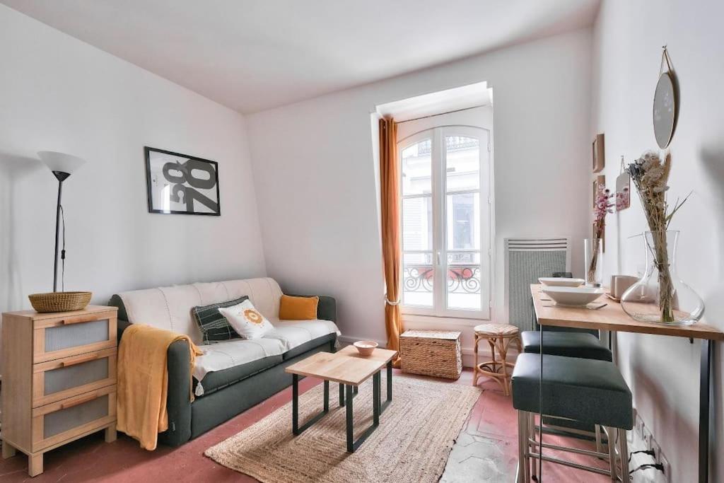 a living room with a couch and a table at Wonderful Studio at Place de la Bastille in Paris