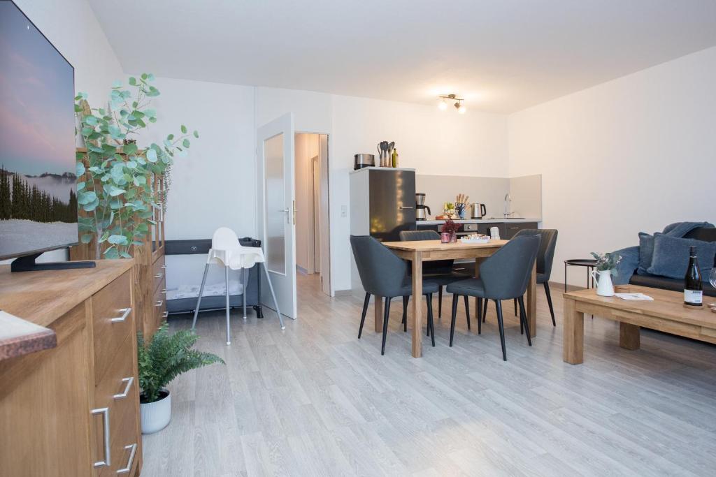 a kitchen and dining room with a table and chairs at Deluxe Apartment - Sauna & Pool - Free Parking in Winterberg