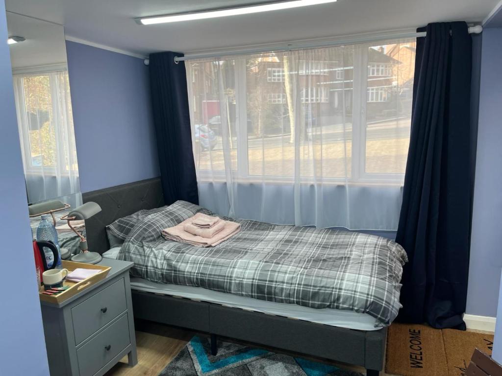 a small bedroom with a bed and a window at Cozy Guest Room in High Barnet (London) with Private Entrance and Small Terrace in London