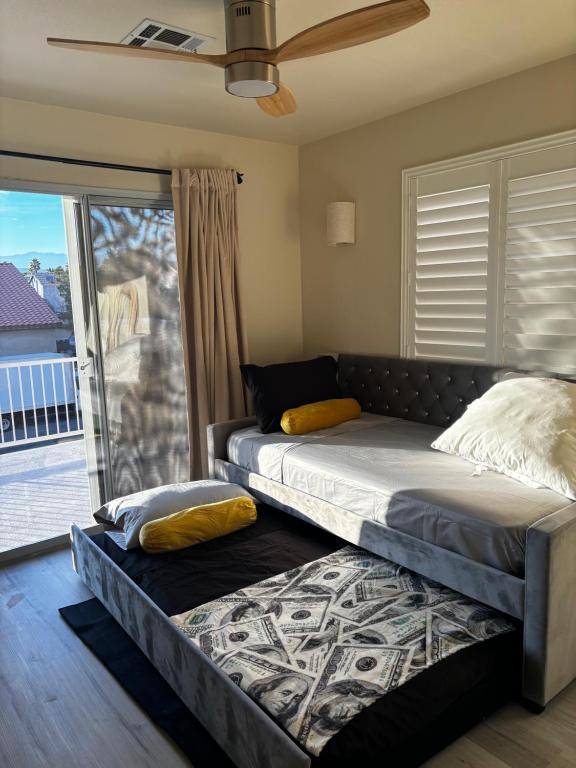 a bedroom with two beds and a balcony at Fragrant Finnish Sauna & Cozy Pool with French 3br in Las Vegas