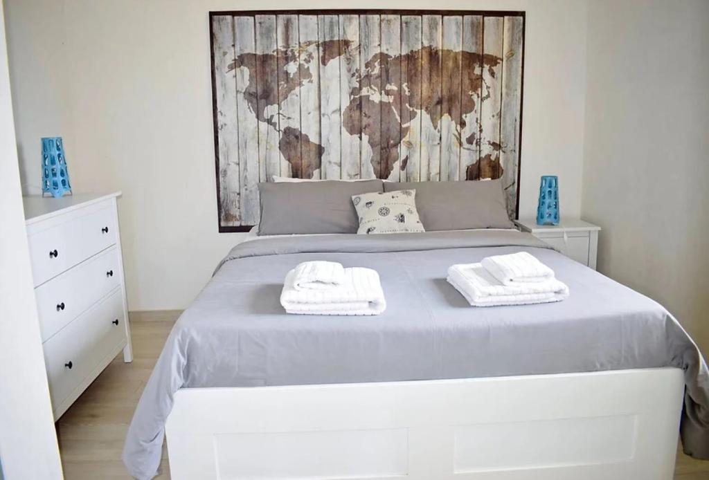 a bedroom with a bed with two towels on it at Harbor Houses II in Marzamemi